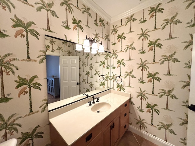 bathroom featuring tile patterned floors, wallpapered walls, vanity, baseboards, and crown molding