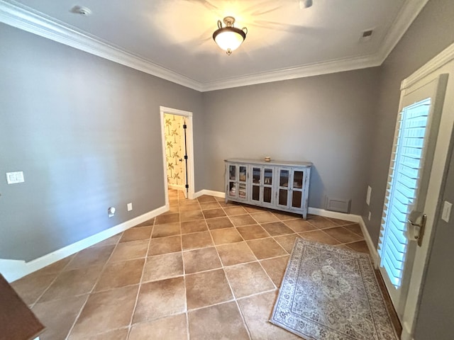 tiled empty room with ornamental molding, visible vents, and baseboards