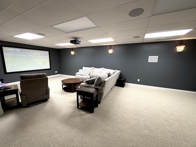 carpeted cinema with baseboards and a drop ceiling