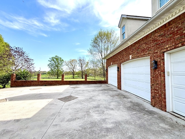 garage with concrete driveway