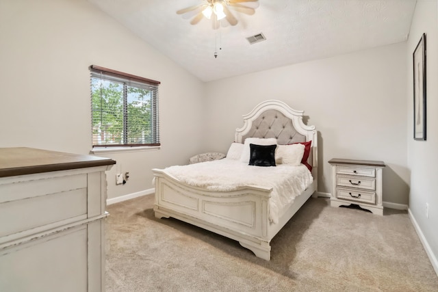 bedroom with visible vents, vaulted ceiling, light carpet, and baseboards