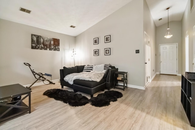 bedroom featuring visible vents, high vaulted ceiling, wood finished floors, and baseboards