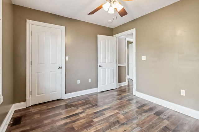 unfurnished bedroom with baseboards, visible vents, and wood finished floors