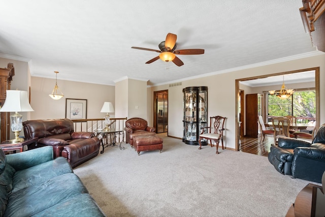 living room featuring ornamental molding, carpet, ceiling fan with notable chandelier, and visible vents