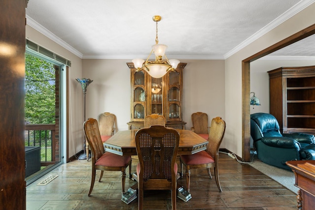 dining space with wood-type flooring, a notable chandelier, and ornamental molding