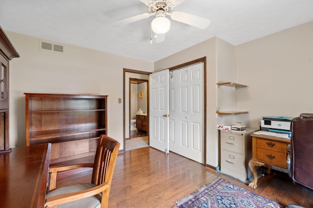 office area featuring visible vents, ceiling fan, and wood finished floors