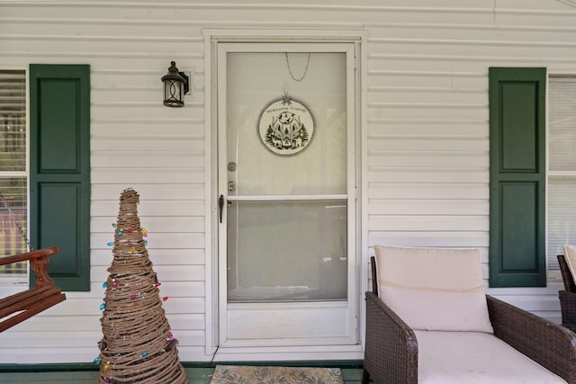 view of exterior entry featuring a porch