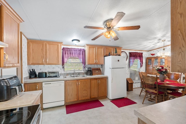 kitchen with a sink, ceiling fan, white appliances, light countertops, and a toaster