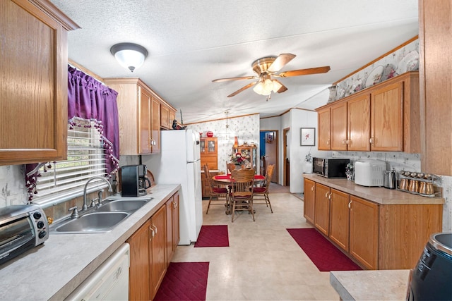 kitchen featuring white appliances, light floors, light countertops, a sink, and a ceiling fan