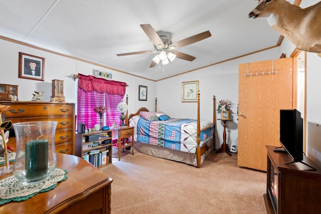 carpeted bedroom with ornamental molding, a ceiling fan, and vaulted ceiling