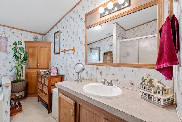 full bathroom with lofted ceiling, ornamental molding, and wallpapered walls