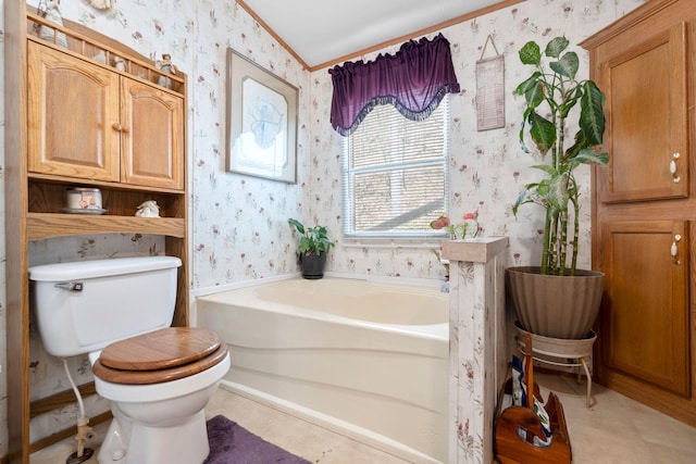 bathroom featuring a garden tub, toilet, ornamental molding, and wallpapered walls