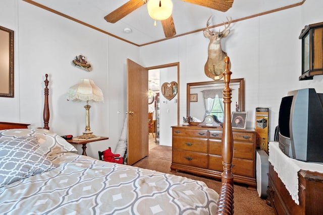 carpeted bedroom with ornamental molding and a ceiling fan