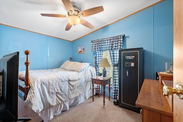 carpeted bedroom with lofted ceiling, a ceiling fan, and ornamental molding
