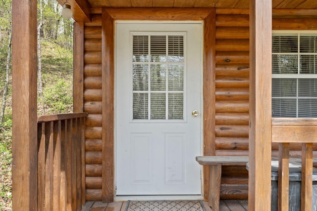 property entrance featuring faux log siding