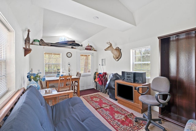 living area featuring a wealth of natural light, carpet flooring, and vaulted ceiling