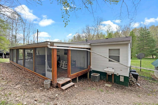 back of house with a sunroom and central air condition unit