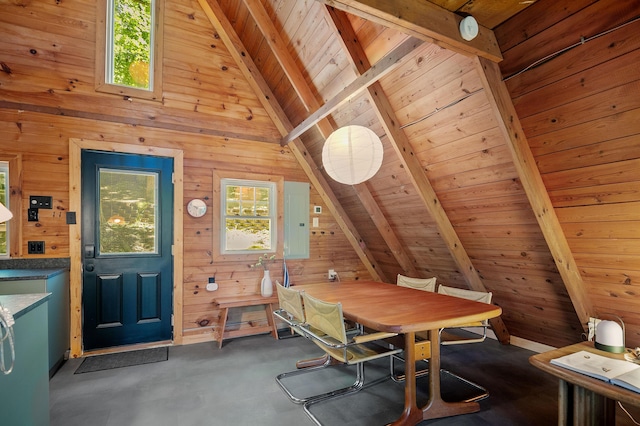 dining room featuring wooden walls, vaulted ceiling with beams, and wood ceiling