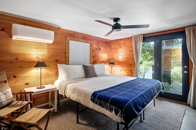bedroom with wooden walls, ceiling fan, a wall unit AC, and access to exterior