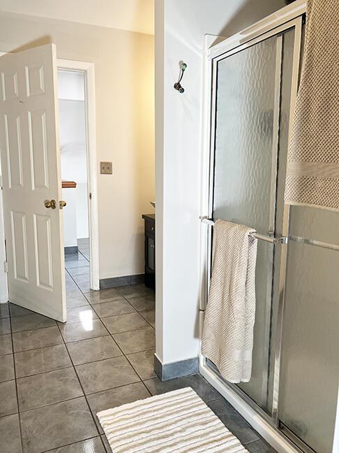 3426 Pepperhill Rd, Lexington, KY 40502 - bathroom featuring a shower stall, vanity, tile patterned floors, and baseboards