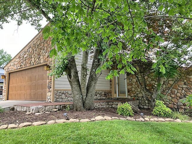 3426 Pepperhill Rd, Lexington, KY 40502 - obstructed view of property with stone siding and an attached garage