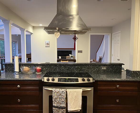 3426 Pepperhill Rd, Lexington, KY 40502 - kitchen with stainless steel range with electric stovetop, island range hood, dark stone counters, ornate columns, and open floor plan