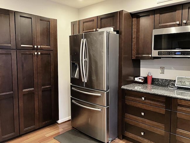 3426 Pepperhill Rd, Lexington, KY 40502 - kitchen with stainless steel appliances, light wood-type flooring, stone countertops, and dark brown cabinetry