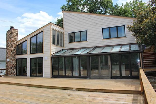 3426 Pepperhill Rd, Lexington, KY 40502 - back of property with a sunroom, a deck, a standing seam roof, and metal roof