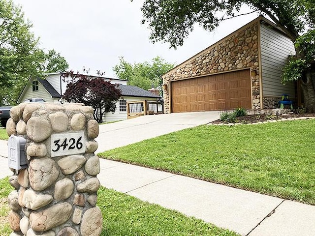 3426 Pepperhill Rd, Lexington, KY 40502 - view of front of property with stone siding, a front yard, and an attached garage