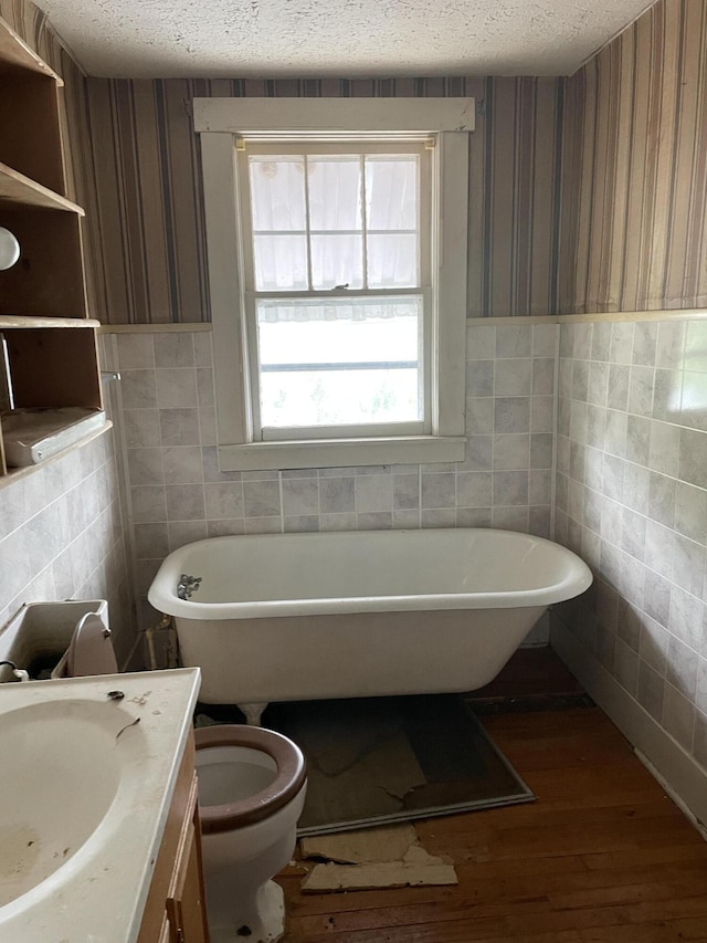 346 Slate Ave, Owingsville, KY 40360 - bathroom with tile walls, a freestanding bath, and a textured ceiling