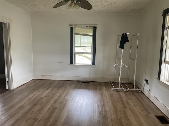 346 Slate Ave, Owingsville, KY 40360 - unfurnished room featuring visible vents, wood finished floors, a ceiling fan, and a textured ceiling