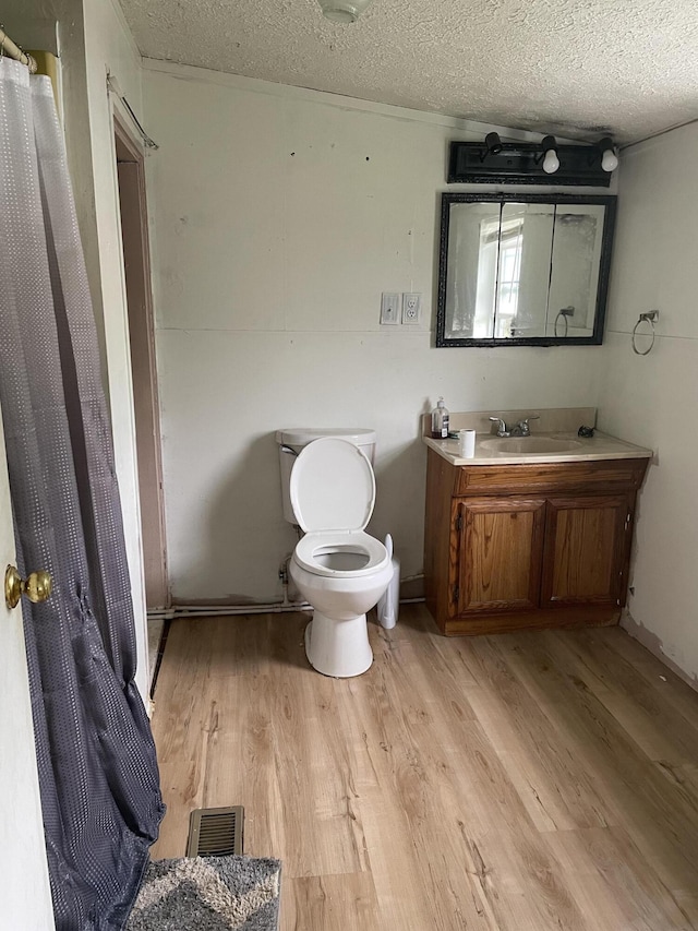 346 Slate Ave, Owingsville, KY 40360 - full bathroom with a textured ceiling, visible vents, and wood finished floors