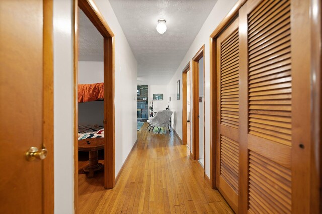 507 Holman Dr, Stanton, KY 40380 - hallway with light wood finished floors and a textured ceiling