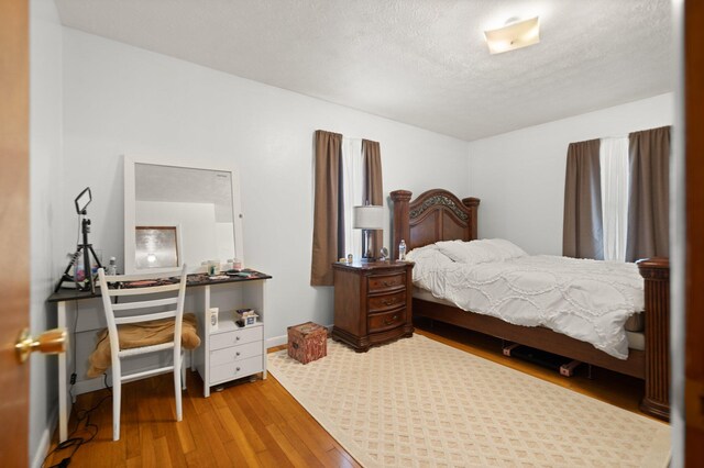 507 Holman Dr, Stanton, KY 40380 - bedroom featuring wood finished floors and a textured ceiling