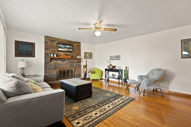 507 Holman Dr, Stanton, KY 40380 - living room featuring a ceiling fan, wood finished floors, baseboards, and a fireplace