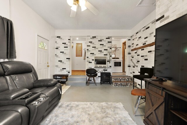 507 Holman Dr, Stanton, KY 40380 - living area with ceiling fan, concrete floors, heating unit, and washer / clothes dryer