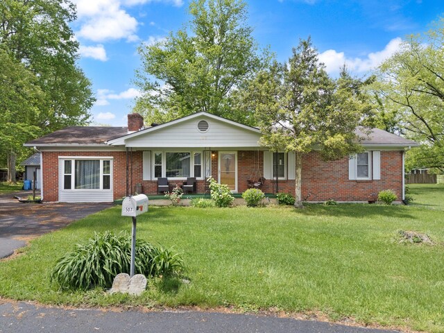 507 Holman Dr, Stanton, KY 40380 - ranch-style home featuring a porch, brick siding, a chimney, and a front yard