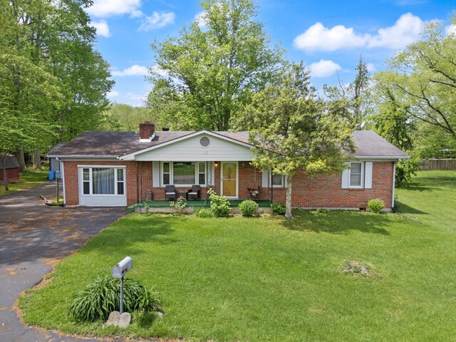 507 Holman Dr, Stanton, KY 40380 - ranch-style house with a porch, brick siding, a chimney, a front yard, and asphalt driveway