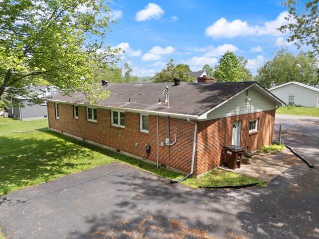 507 Holman Dr, Stanton, KY 40380 - back of house with brick siding, a lawn, a shingled roof, and a chimney