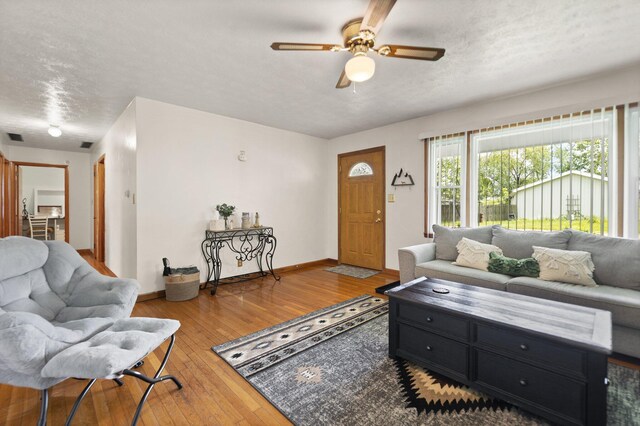 507 Holman Dr, Stanton, KY 40380 - living room with a ceiling fan, hardwood / wood-style flooring, baseboards, and a textured ceiling