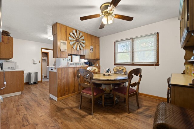 507 Holman Dr, Stanton, KY 40380 - dining room featuring ceiling fan, wood finished floors, and baseboards
