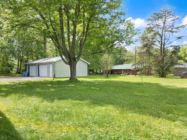 507 Holman Dr, Stanton, KY 40380 - view of green lawn featuring an outdoor structure and a detached garage