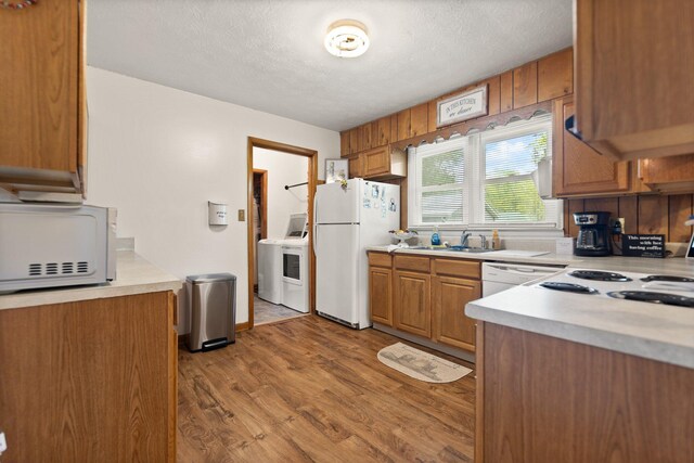 507 Holman Dr, Stanton, KY 40380 - kitchen with white appliances, washer / clothes dryer, light countertops, a textured ceiling, and wood finished floors