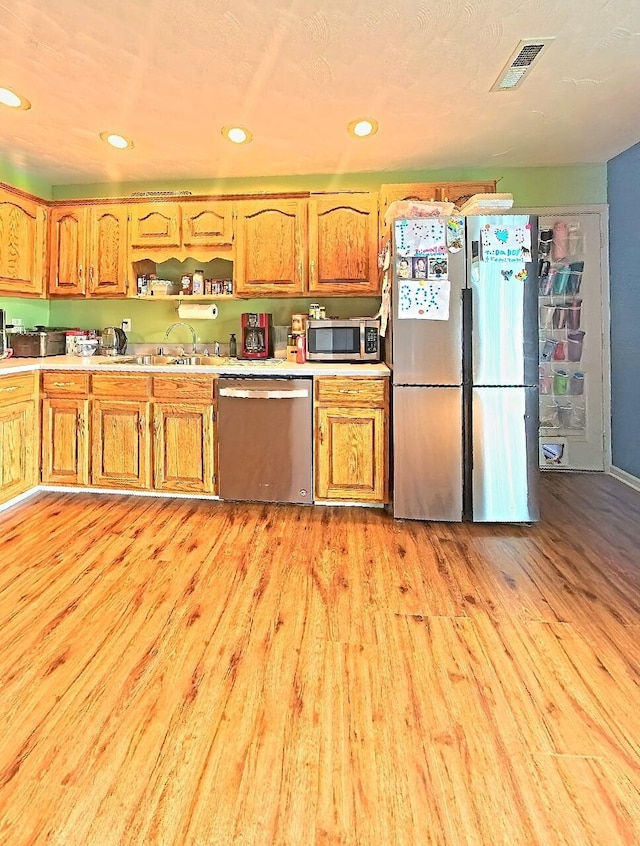 17 Jessica Way, Stanford, KY 40484 - kitchen with stainless steel appliances, light wood-style flooring, light countertops, brown cabinetry, and open shelves