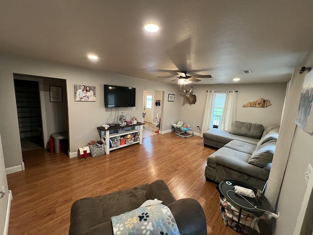 living area with recessed lighting, a ceiling fan, visible vents, baseboards, and wood finished floors