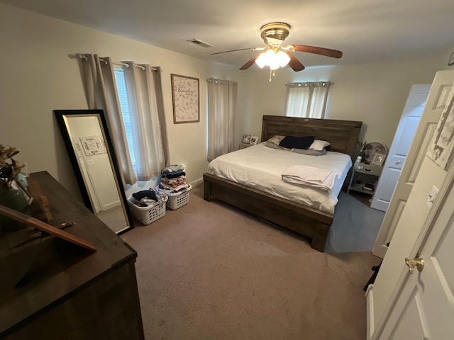 bedroom with visible vents, ceiling fan, and carpet