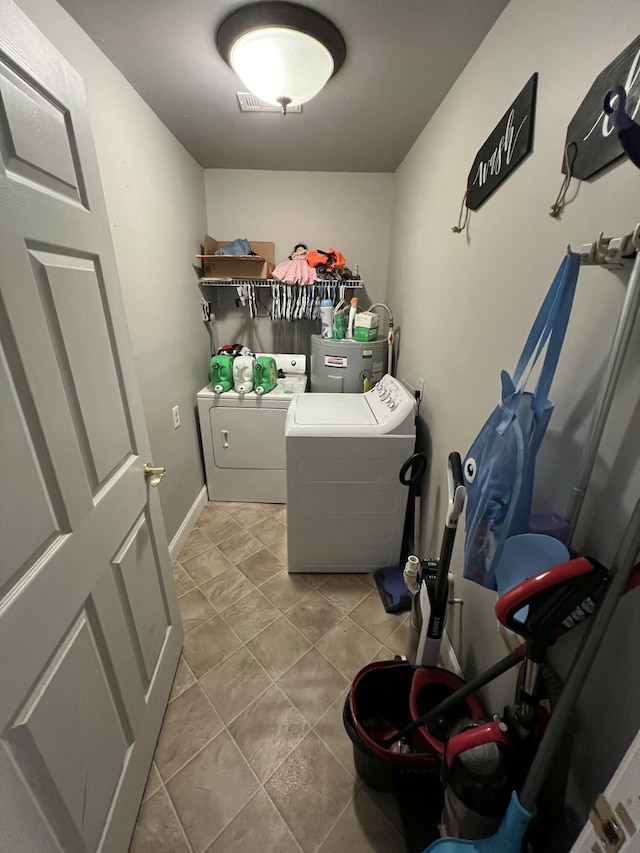 clothes washing area featuring tile patterned floors, laundry area, and independent washer and dryer