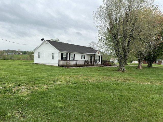 back of house with a deck and a lawn