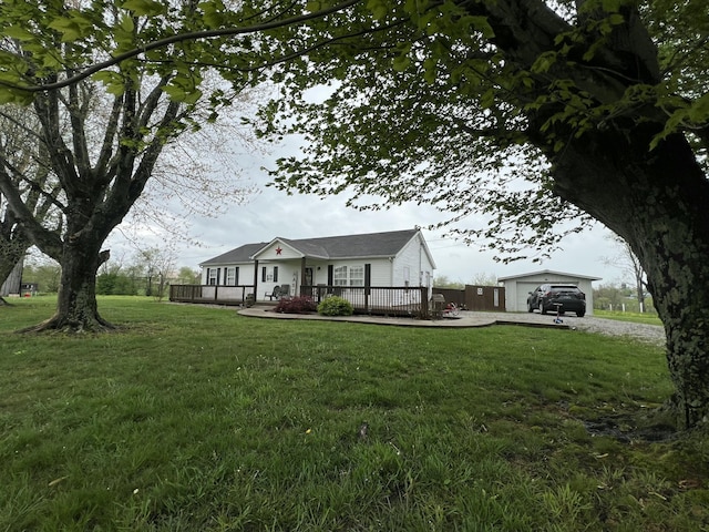 view of front of property with a front lawn, a wooden deck, and driveway