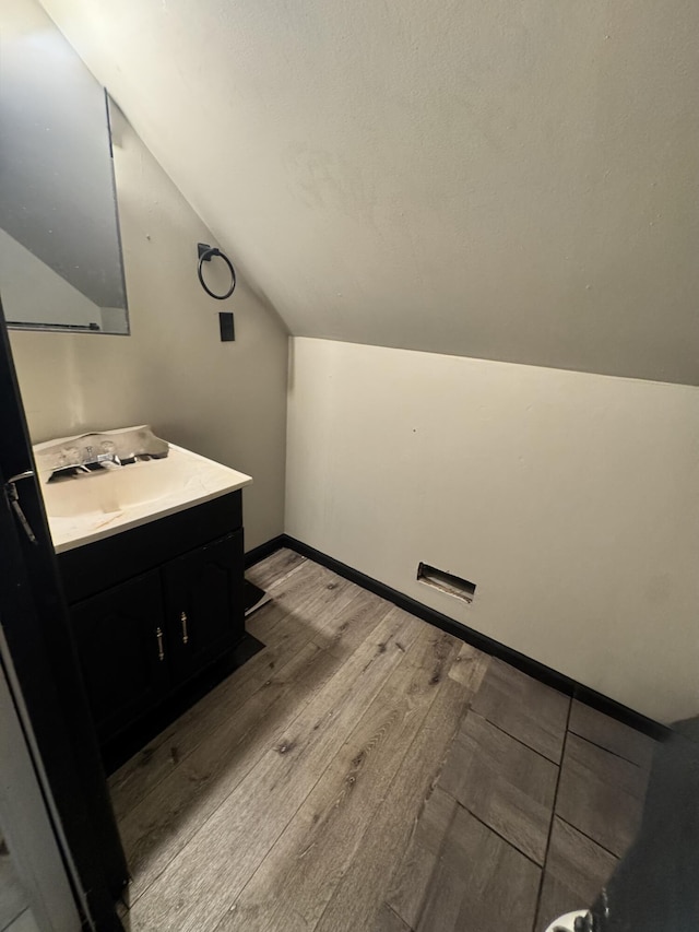 68 Red Witt Rd, Williamsburg, KY 40769 - bathroom featuring vanity, vaulted ceiling, wood finished floors, and baseboards